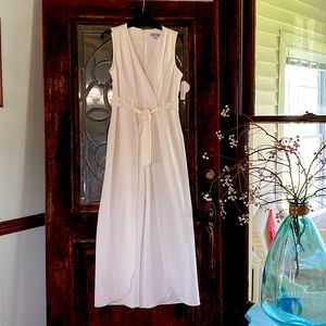 White jump suit with shorts built in. Wide open leg . V neck with zipper back.